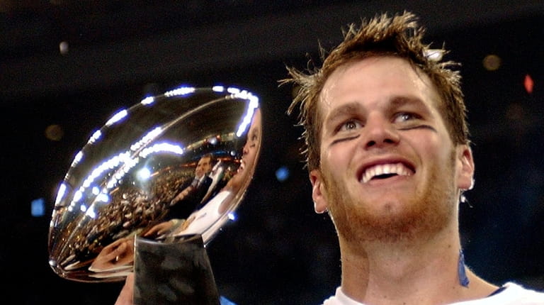 FILE - New England Patriots quarterback Tom Brady holds the...