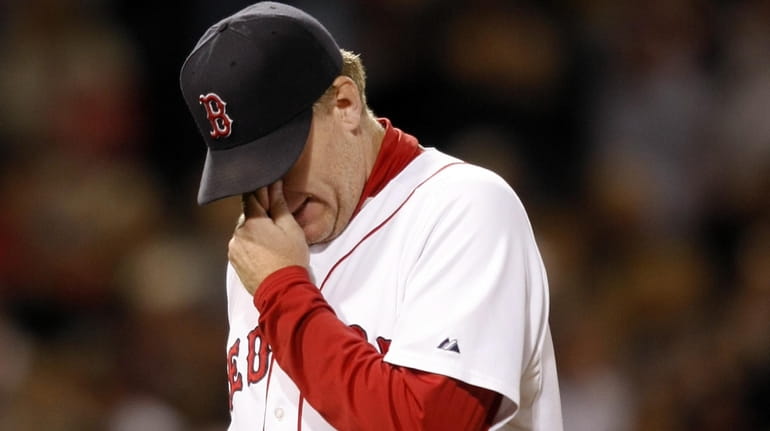 Red Sox pitcher Curt Schilling walks off the mound after he...