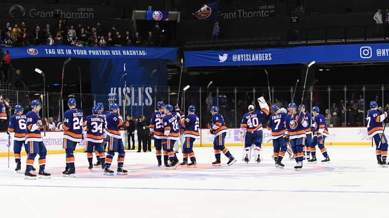 New York Islanders players celebrate their 2-1 win against the...