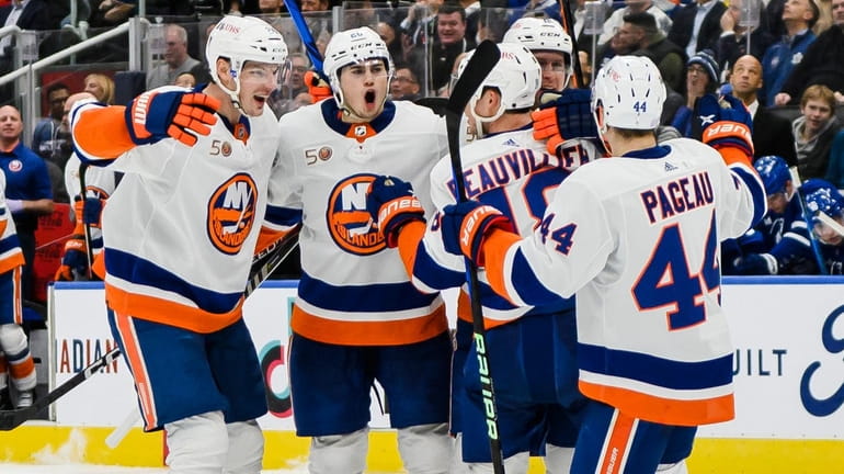 The Islanders celebrate after teammate Josh Bailey scored against the Maple Leafs...