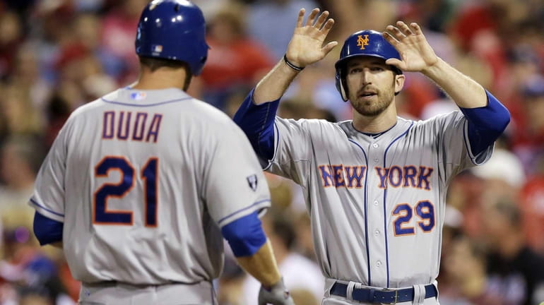 Ike Davis, right, and Lucas Duda celebrate after Duda's two-run...