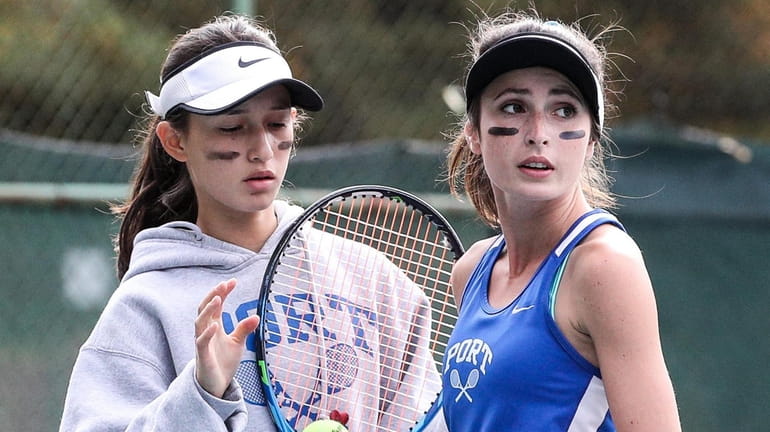 Port Washington's Dasha Perfiliev, left, and Charlotte Forman check the competition...