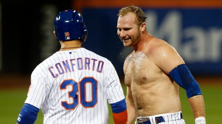 Pete Alonso of the Mets celebrates his ninth-inning walk-off walk against...