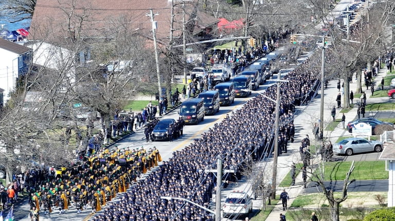 Thousands of police officers and mourners gather in Massapequa for...