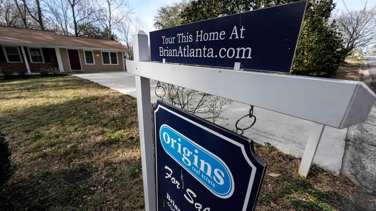 A sign announcing a home for sale is shown on...