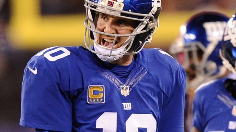 Eli Manning reacts during the first half of a game...