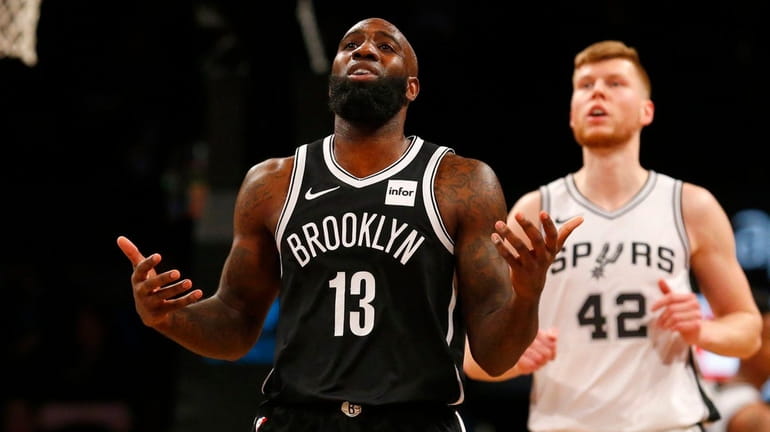 Quincy Acy of the Nets reacts during the first half...
