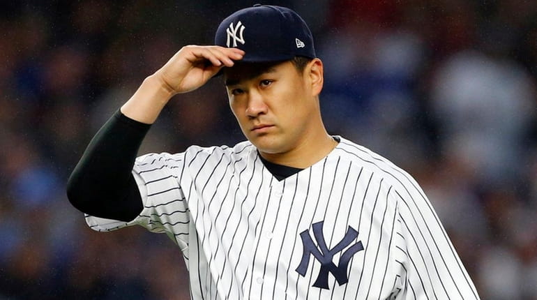 Masahiro Tanaka of the New York Yankees walks to the...