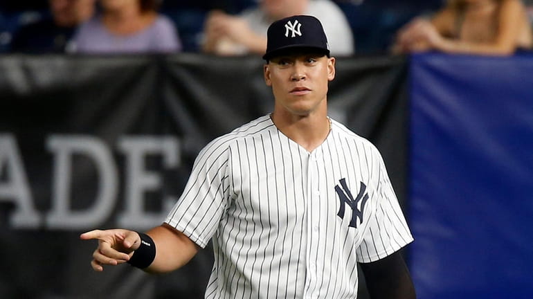 Aaron Judge of the Yankees stands in the outfield during the...