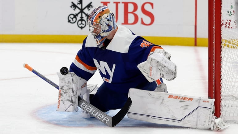 Ilya Sorokin #30 of the Islanders makes a save in the...