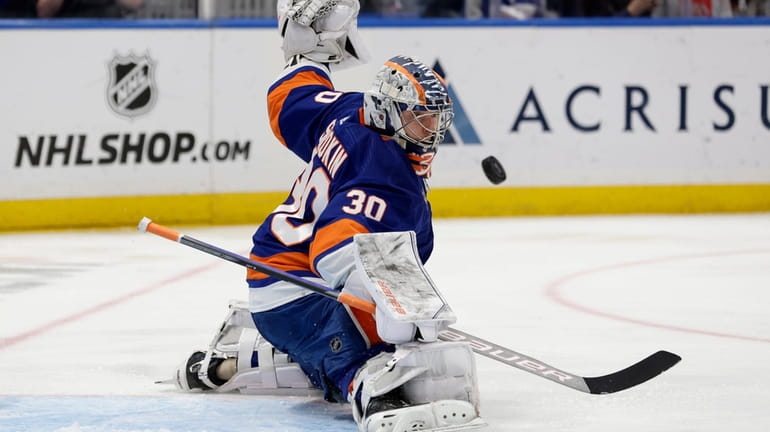 Ilya Sorokin of the New York Islanders makes a save against...
