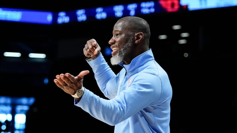 Dayton head coach Anthony Grant calls out to his team...
