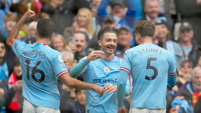 Manchester City's Jack Grealish, center, celebrates with teammates after scoring...