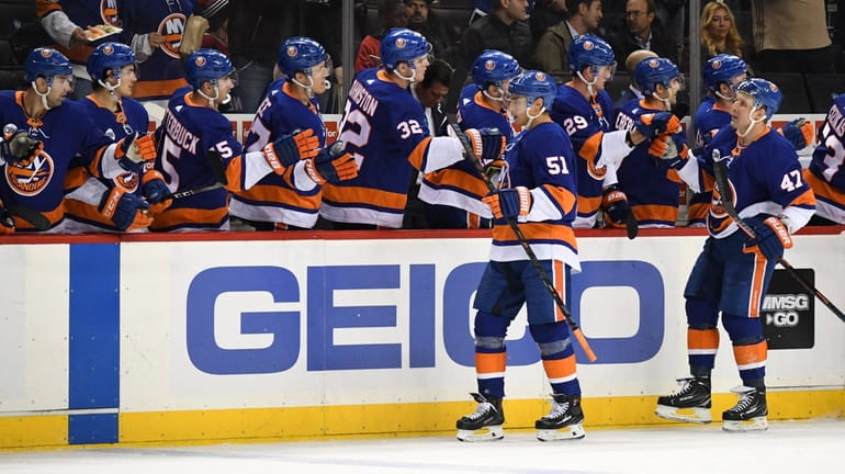 Islanders players congratulate center Valtteri Filppula after scoring a goal against the Canadiens during...