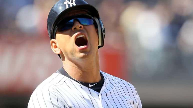 Alex Rodriguez reacts after almost hitting a home run during...