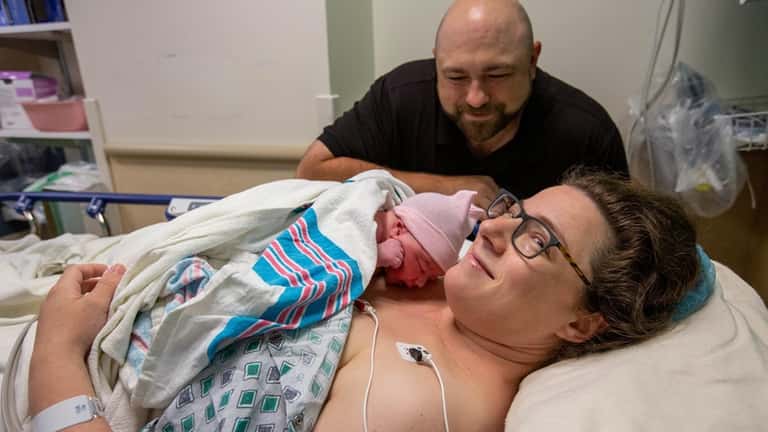 Rachel and Michael Vicario, of Mineola, welcome their third child,...