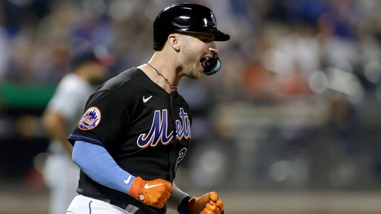 Pete Alonso of the Mets celebrates his seventh-inning two-run home run against...