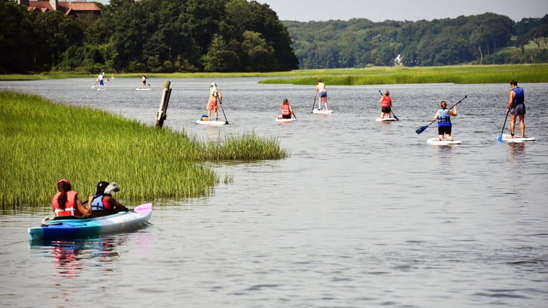 Kayakers and paddle boarders try to stay cool in Stony Brook...