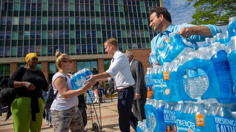 City officials hand out cases of bottled water to Long Beach...