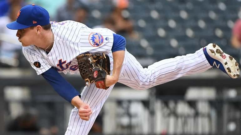Mets relief pitcher Drew Smith delivers against the Miami Marlins...