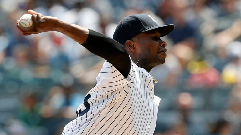 Domingo German #55 of the Yankees pitches during the first inning...