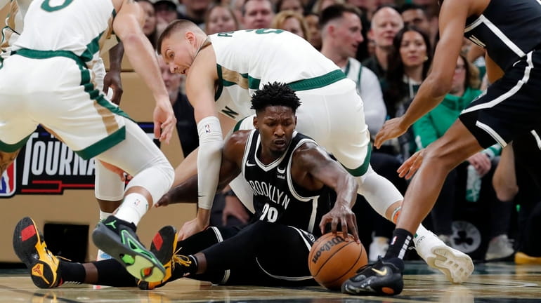 Nets' Day'Ron Sharpe, bottom center, battles Boston Celtics' Jayson Tatum...