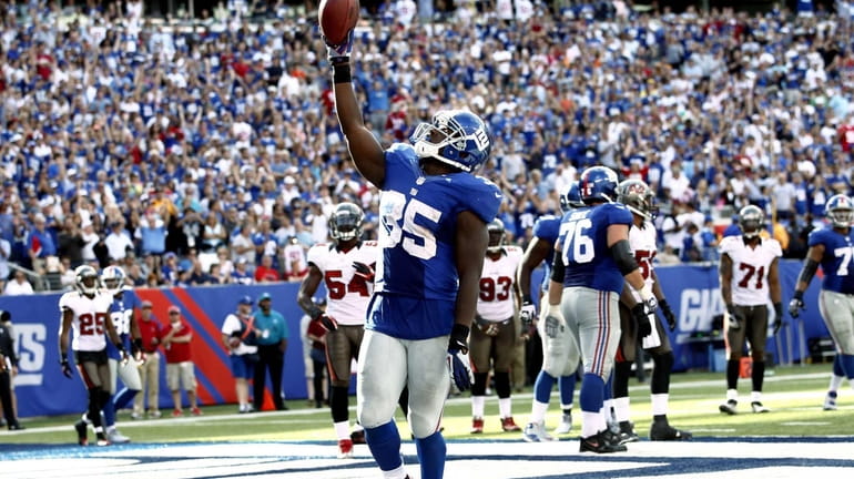 Andre Brown celebrates a touchdown against the Tampa Bay Buccaneers...