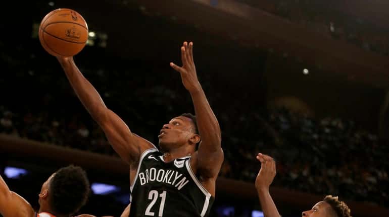 The Nets' Treveon Graham goes to the hoop in the...