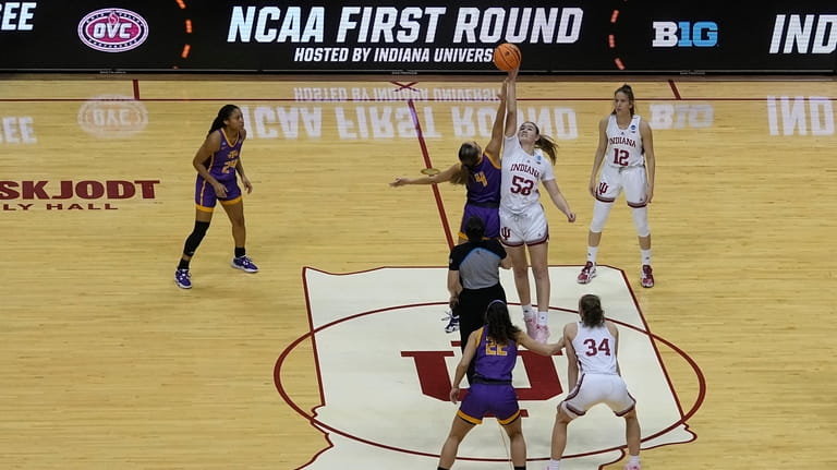 Tennessee Tech's Anna Walker (4) and Indiana's Lilly Meister (52)...