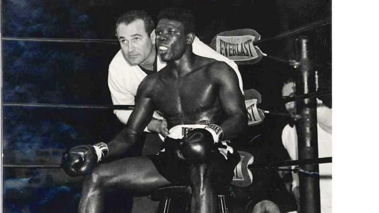 Boxing coach Gil Clancy advises Emile Griffith before he heads...