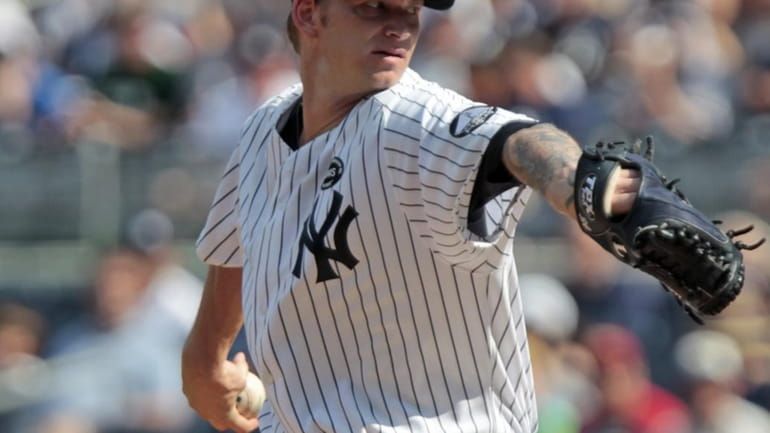 New York Yankees' A.J. Burnett delivers a pitch during the...