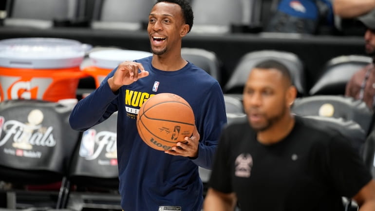 Denver Nuggets guard Ish Smith jokes with teammates during practice...