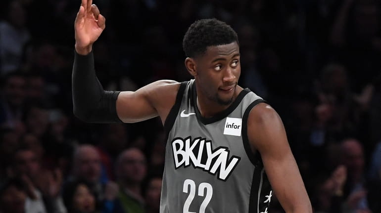 Nets guard Caris LeVert reacts after he sinks a three-pointer...