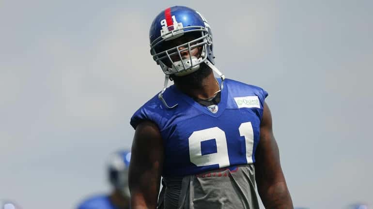 Robert Ayers of the Giants looks on during training camp...