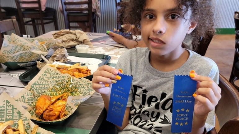 Layla Salazar shows her first-place ribbons from field day at...