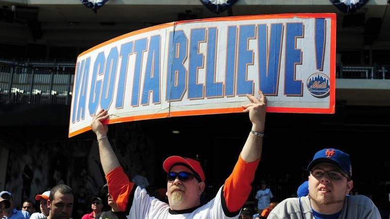 A New York Mets fan displays a sign during practice...