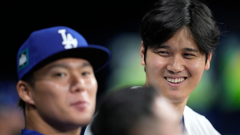 Los Angeles Dodgers designated hitter Shohei Ohtani, right, talks with...