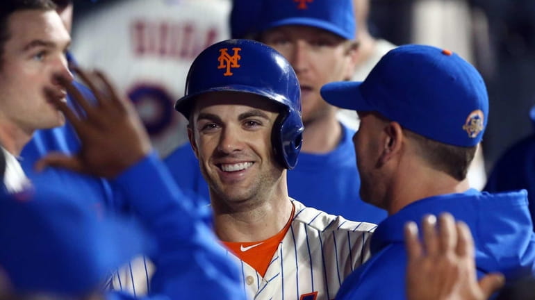 David Wright celebrates after scoring in the fourth inning of...