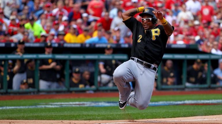 Marlon Byrd of the Pittsburgh Pirates slides home to score...