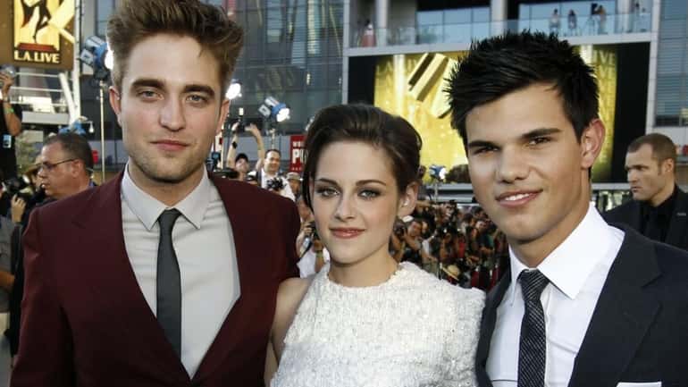 From left, Robert Pattinson, Kristen Stewart and Taylor Lautner arrive...