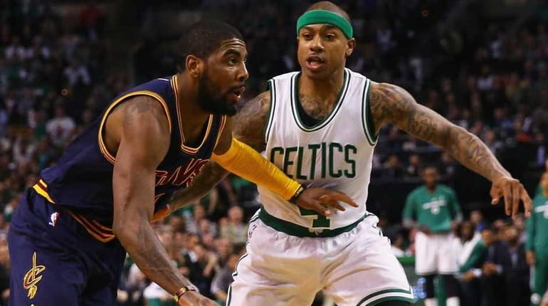 Kyrie Irving of the Cavaliers, left, drives against Boston's Isaiah...