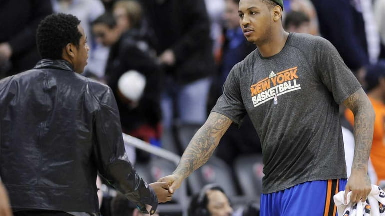 New York Knicks' Carmelo Anthony, right, shakes hands with entertainer...