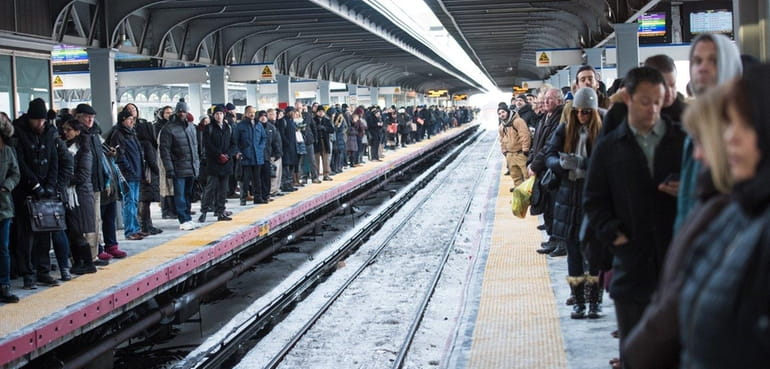 Commuters wait on both platforms for the Long Island Rail...