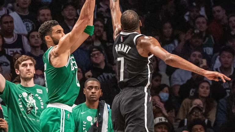 The Celtics' Jaylen Tatum shoots over the Nets' Kevin Durant in...