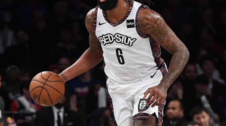 Brooklyn Nets center DeAndre Jordan dribbles th ball up court...