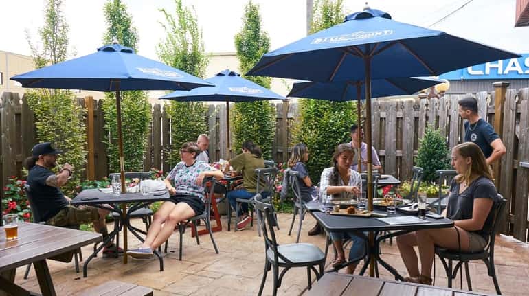 The outdoor seating area at Garden Social in East Meadow...