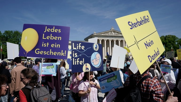 Participants in the 'March for Life' rally stand with banners...