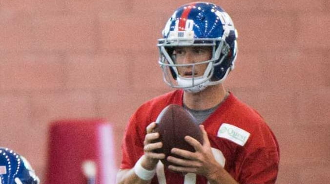 New York Giants quarterback Eli Manning takes the snap during...