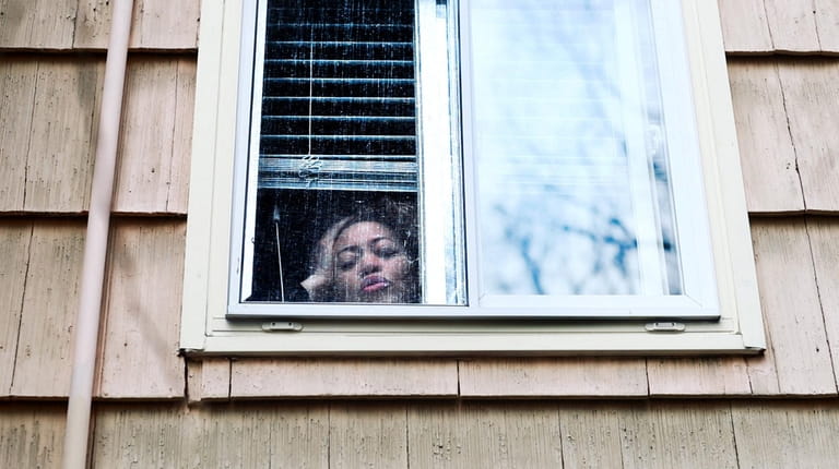Dr. Michele Reed of Lakeview looks out her bedroom window....