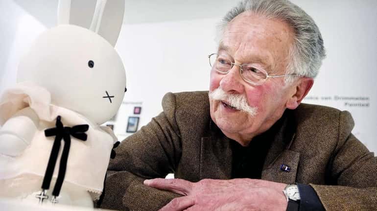 Dutch author and illustrator Dick Bruna poses next to a...